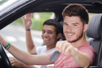 young man driving behind the wheel of the car