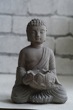 a small stone statue of Buddha