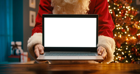 Santa Claus holding a laptop with blank screen