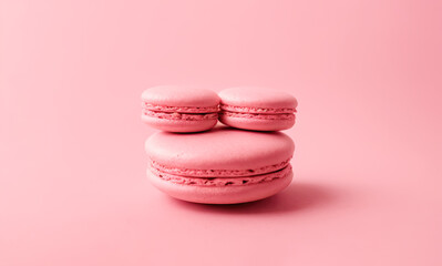Fototapeta premium pink macaroon on minimalistic pink background. Pink French macaroon in center on pink background Generative AI