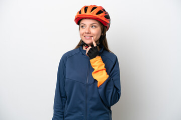 Young cyclist Lithuanian woman isolated on white background thinking an idea while looking up