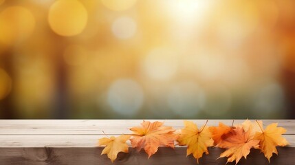 Naklejka na ściany i meble Wooden table with maple leaves on autumn background