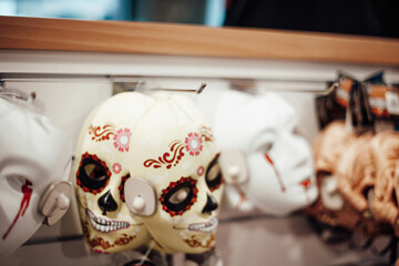 Display wall of halloween scary faces masks on sale in joke shop