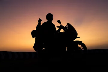 Abwaschbare Fototapete biker men and classic motorcycle at sunset © Rahul