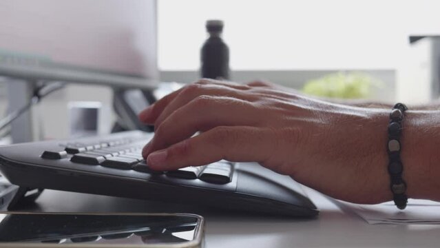Man hands typing on computer keyboard, while working searching information online close up. Fingers pressing buttons while writing message on pc, browsing internet close view