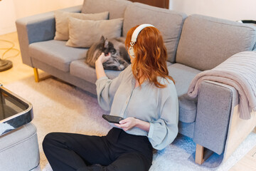 A woman is using a smartphone at home