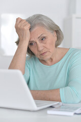 old woman with a laptop on a white background