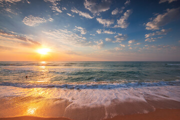 Beautiful tropical sunrise over the sea horizon and beach shore
