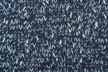 Sweater or scarf fabric texture large knitting. Knitted jersey background with a relief pattern. Wool hand- machine, handmade.