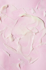 Obraz na płótnie Canvas Creamy texture on a pink background, abstract image