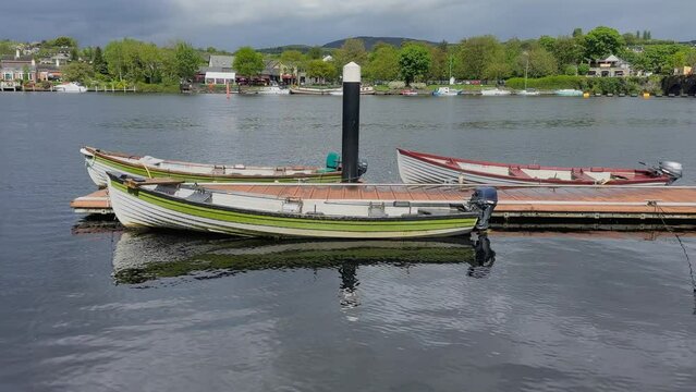 River water reflects sunshine onto gunwale of old wooden motorboat