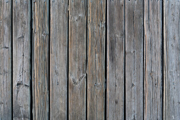 Rustic wooden planks placed in vertical format with a very marked texture due to the passage of time