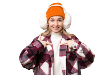 Young  English woman wearing winter muffs over isolated background with surprise facial expression