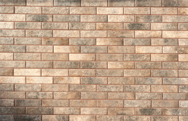 A fragment of a modern wall laid out of beige bricks under the framework