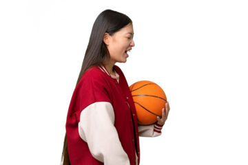 Young basketball player asian woman over isolated background laughing in lateral position