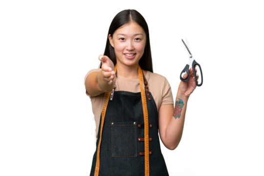 Young Asian seamstress woman over isolated background shaking hands for closing a good deal