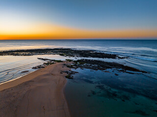 Sunrise with clear skies and calm seas