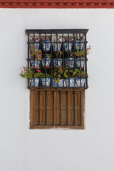 A picturesque Andalusian window adorned with potted plants and flowers