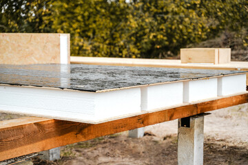 Building construction of wooden frame house made of SIP structural insulated panels. OSB oriented...