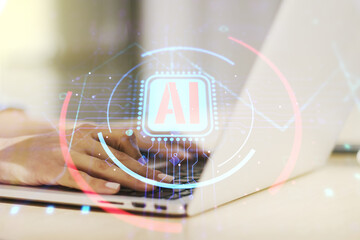 Double exposure of creative artificial Intelligence abbreviation with hand typing on computer...