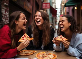 Tuinposter Beautiful women girlfriends in pizzeria © cherezoff