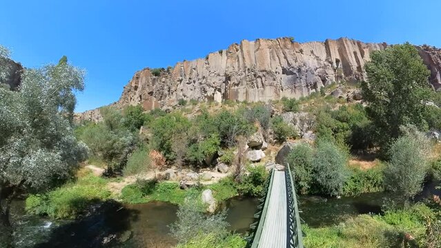Ihlara Valley in Turkey Cappadocia. Ihlara valley is carved by Melendiz River and features towering rock cliffs that rise up to 100 meters high with caves and rock-cut churches that dot its landscape