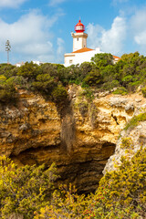 Fototapeta na wymiar Farol de Alfanzina Lighthouse in Algarve Coast, Portugal