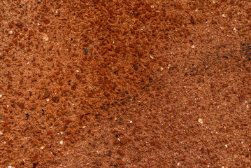 The grunge texture of terracotta plaster. Rough wall treatment, rough wall. Textured background