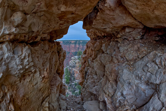 A gap between a stack of balanced boulders on a cliff east of Grandview Point at Grand Canyon South Rim, Grand Canyon National Park, UNESCO World Heritage Site, Arizona, United States of America