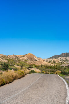 Road in Tabernas desert on a sunny day, Almeria, Andalusia