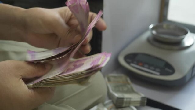 A business counting 2000 Indian rupee banknotes, Cash in hand counting, Lot of cash during transaction, Closeup