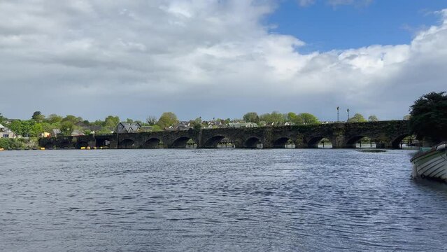Peaceful River Shannon flows under Irish medieval stone arch bridge