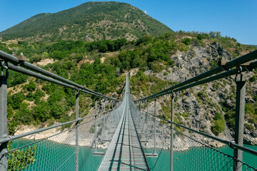 suspension bridge over the monteygnard lake, france