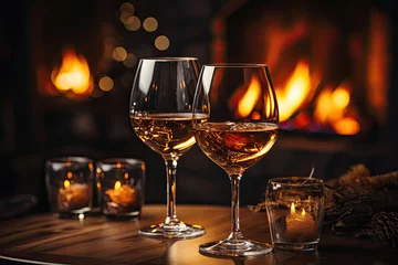 Keuken foto achterwand Two glasses of red wine with fireplace on background in cozy warm holiday atmosphere © sommersby