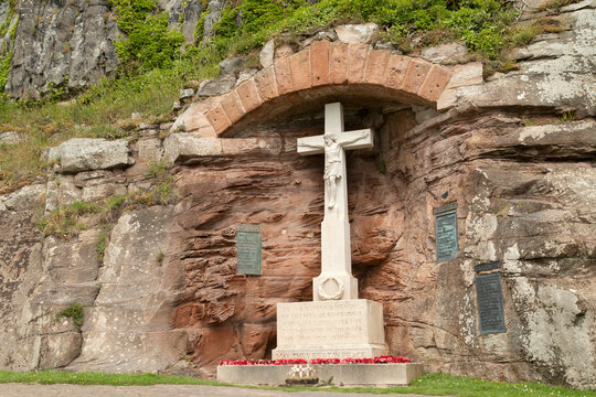 War Memorial, depicting Jesus Christ crucified, in memory of the Fallen of World War One and World War Two, in the village of Bamburgh, Northumberland, England, United Kingdom