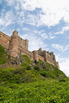 Bamburgh Castle, a hilltop fortress constructed on top of a craggy outcrop of volcanic dolerite, Grade I Listed Building, Bamburgh, Northumberland, England, United Kingdom