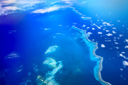 Sky high above the Clouds - Ariel View of the Beautiful Islands and Ocean from the Plane 