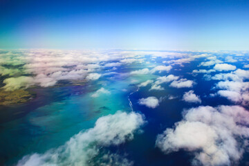 Above the Clouds - Ariel View of Islands and Ocean from the Plane	