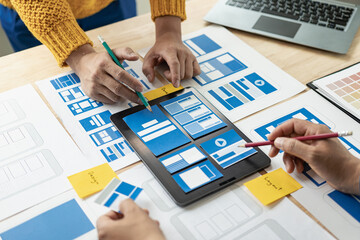 A team of UI UX web designers is working together to develop a mobile responsive website by...