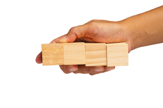 Close-up of hand holding four wooden cubes on a transparent background