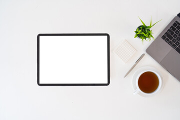 Modern desk workspace with blank copy space mockup with blank screen tablet, coffee cup,...