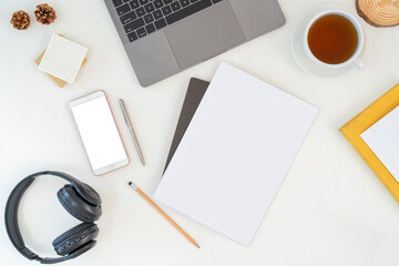 Top view above of white office desk table with keyboard computer, notebook and coffee cup with equipment other office supplies. business and lifestyle concept with blank copy space