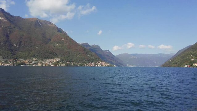 Pan right view from ferryboat, from Laglio town to another side of Lake Como, Pognana Lario village.