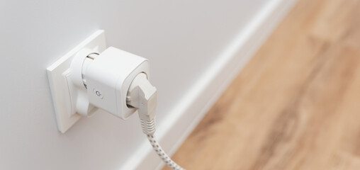 Using smart socket on the wall in a smart home - obrazy, fototapety, plakaty