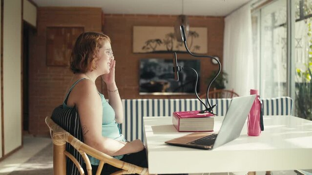 A young woman recording online video content using her smartphone