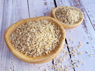 Raw brown rice in a wooden bowl 