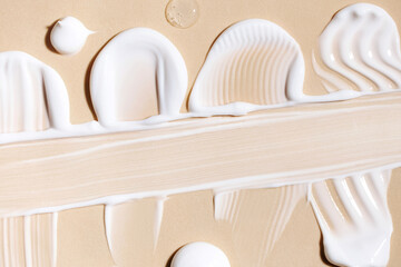 Fototapeta premium cosmetic smears of creamy texture on a beige background