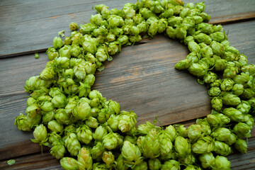 Frame of heart form from fresh cones of hops. Raw material for brewing production.