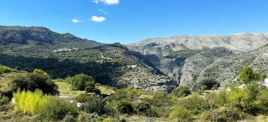 Fototapeta na wymiar Panoramic view of the Hell's Ravine, or El Barranc de l'Infern, in La Vall de Laguar. One of the hardest hiking routes in Spain. The Cavall Verd mountain and the town Benimaurell are in the background
