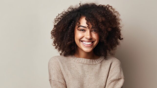 A portrait of youthful exuberance as a teen girl beams with happiness in a well-lit studio environment.